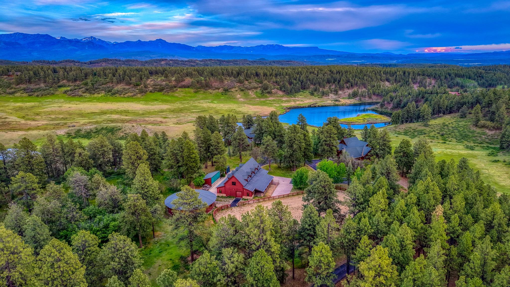 Aerial over the compound to the lake and mountains
