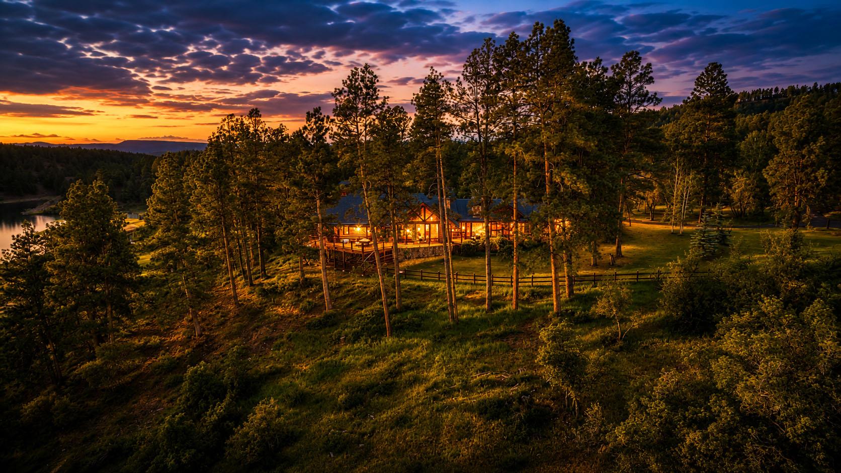 Aerial of the main house at sunset above the lake