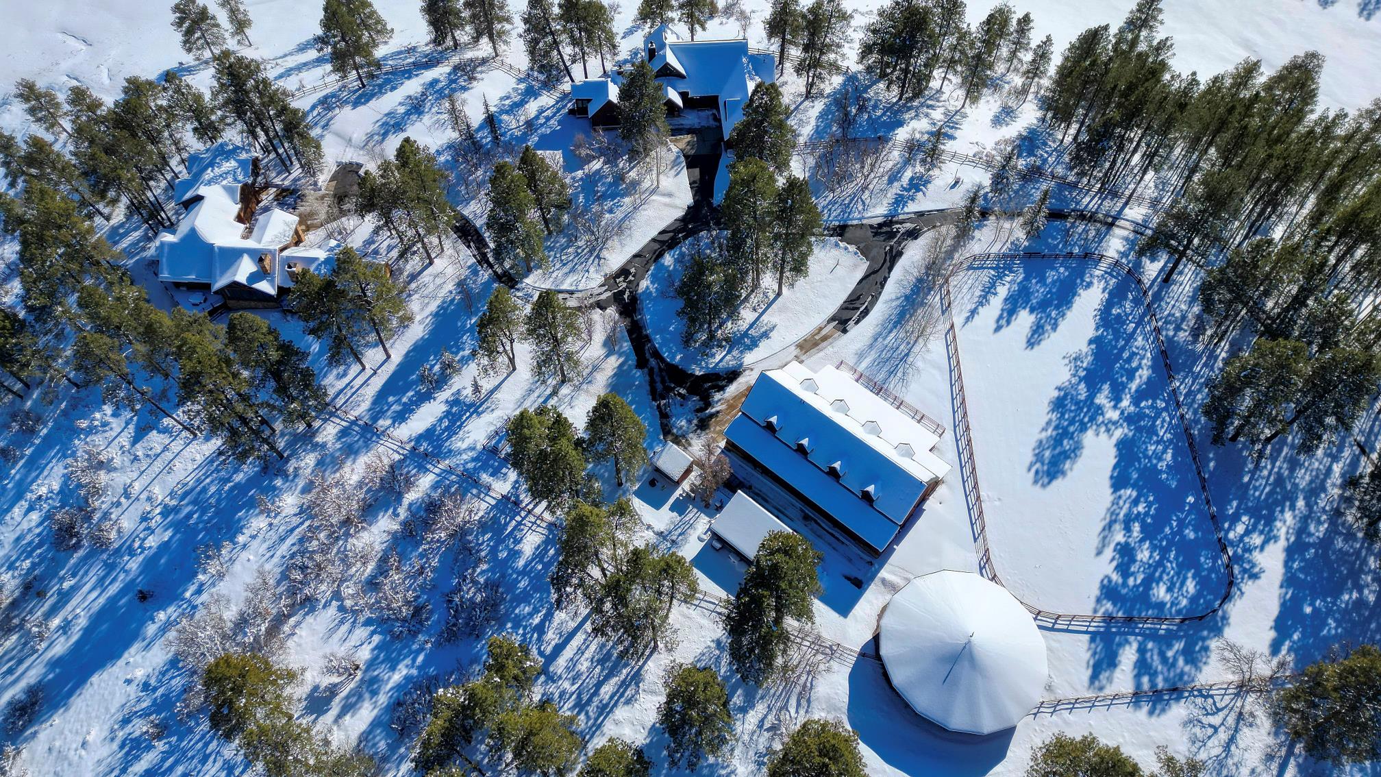 Winter aerial of the barn arena and both homes