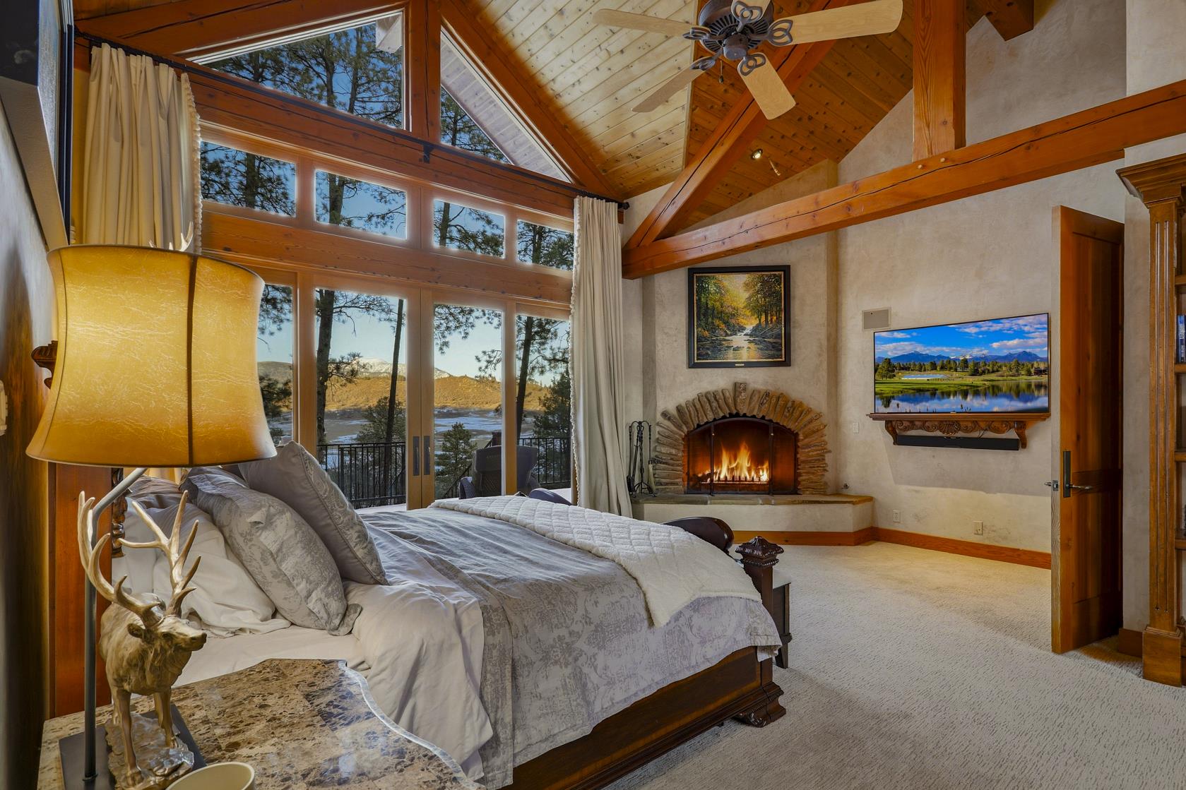 Primary bedroom with fireplace and mountain view