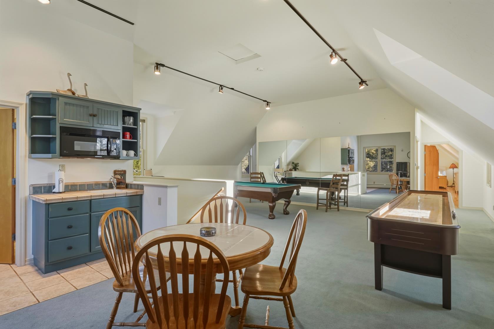 Game room with pool table and shuffleboard